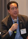 Will Wang speaking in a hand-held microphone
