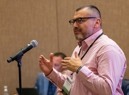 Troy Benavidez speaking in a microphone