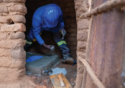 man installing Sato toilet