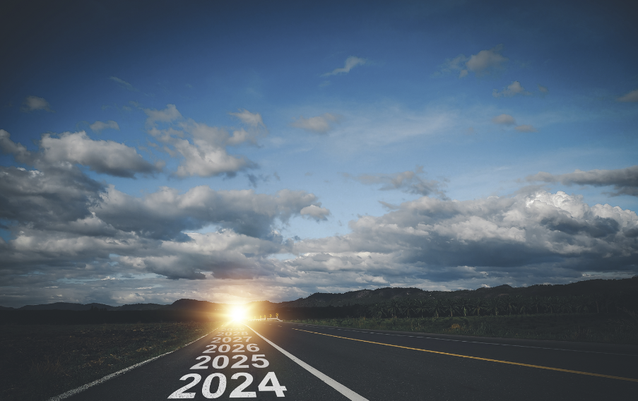 sunset over road with 2024, 2025, 2026 fading into distance