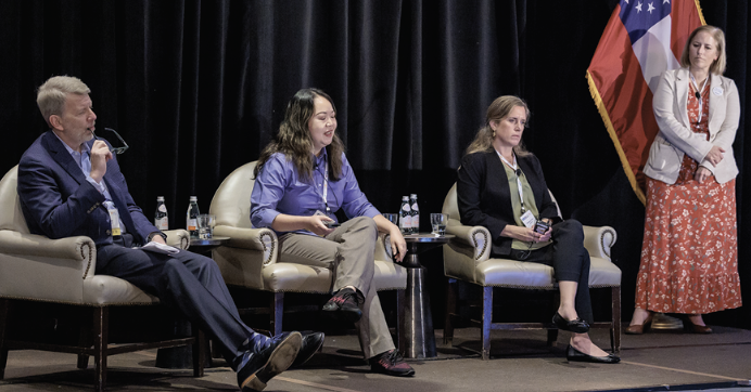 three panel members on stage